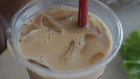 close-up of an iced coffee with a red straw