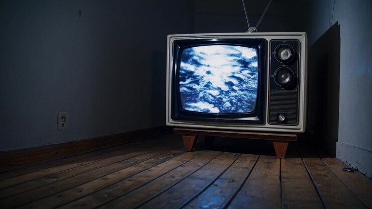 Vintage Television Displaying Abstract Moving Clouds in Dark Room