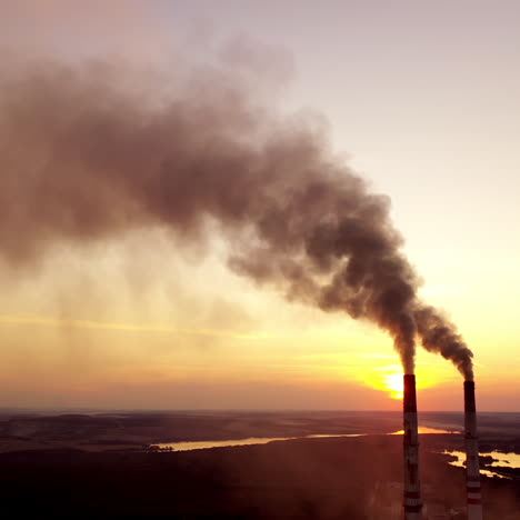 industrial landscape. smoke from pipes of the power plant at sunset. environmental pollution.