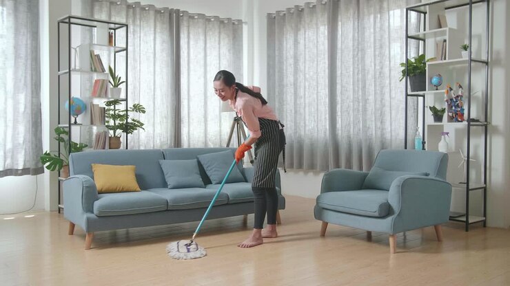 Woman Mopping a Living Room