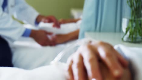 male doctor comforting patient in the ward