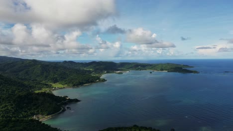 panoramic aerial time-lapse of tropical island coastline and cove with clouds passing at baras, catanduanes, philippines during daytime