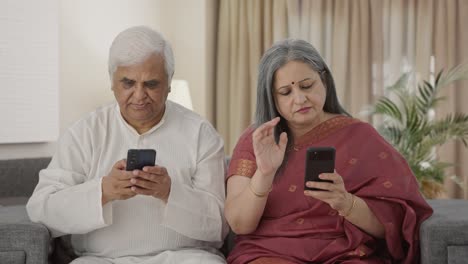 Old-Indian-couple-busy-in-their-phones