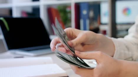 Woman-hand-counting-dollar-bills-in-office.-Female-hands-counting-money-dollars