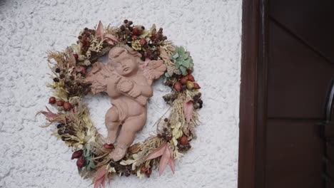 angel figurine in a dried flower wreath