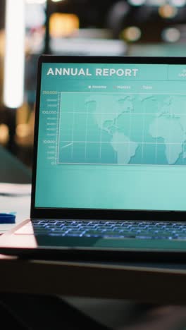 vertical video empty boardroom with a laptop running performance metrics