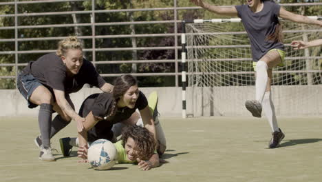 long shot of cheerful female football players rejoicing victory on the field