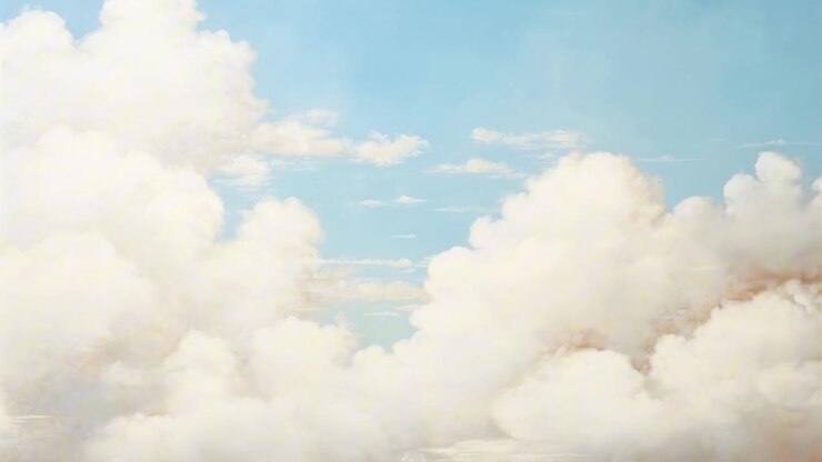 Soft White Clouds Drifting Across a Clear Blue Sky