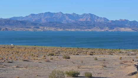 beach view at lake mead with mountains in background, static shot