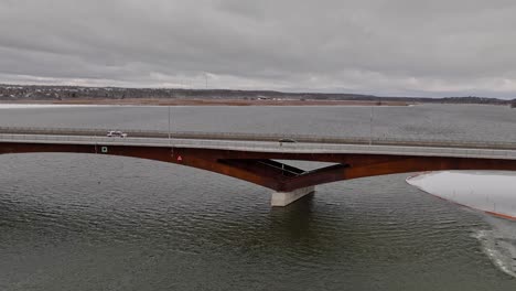 one women looking out on a bridge dolly shot aerial