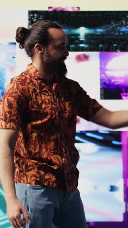 vertical video cool relaxed guy using his smartphone under neon lights