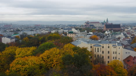 Panorama-of-soft-lighted-tenement-houses-in-Krakow-Old-Town-and-Wawel-Royal-Castle-at-cloudy-morning,-Krakow,-Poland