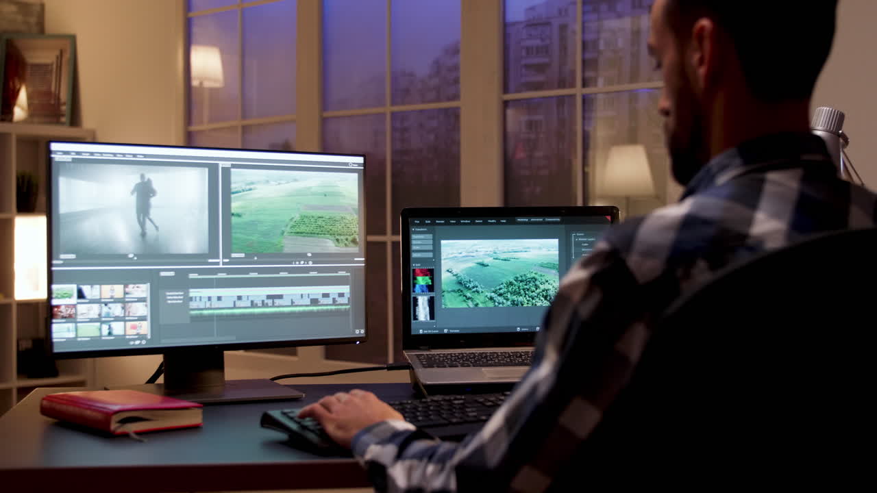Man Editing Video at Desk with Dual Monitors