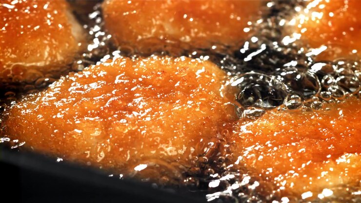 Golden Chicken Nuggets Frying in Hot Oil