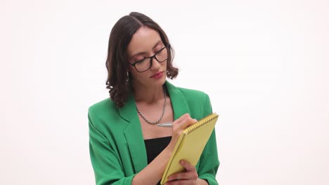 Professional Woman Thinking and Writing in a Notebook