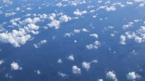 white small cumulus clouds pattern over the blue atlantic ocean from above