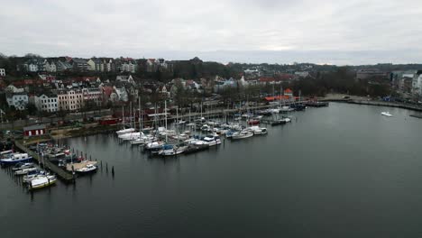 Drone-Flight-towards-the-harbour-of-the-historic-city-in-Flensburg,-Germany