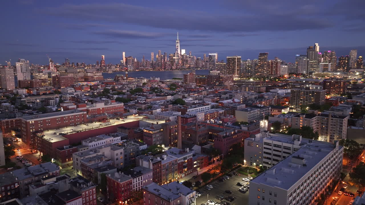 Aerial view of Lower Manhattan at night. Shot in Hoboken, New Jersey with the World Trade Center and the East River in the background.