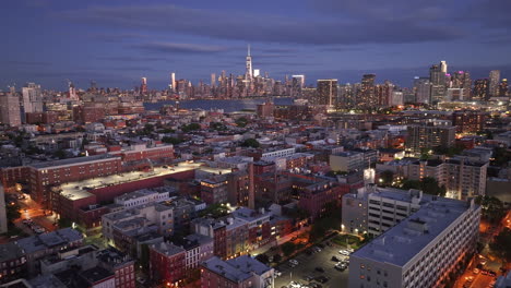 aerial view of lower manhattan at night. shot in hoboken, new jersey with the world trade center and the east river in the background.