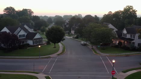 rising aerial reveals suburban homes at sunrise