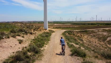 aerial view following with the drone a man on mountain bike