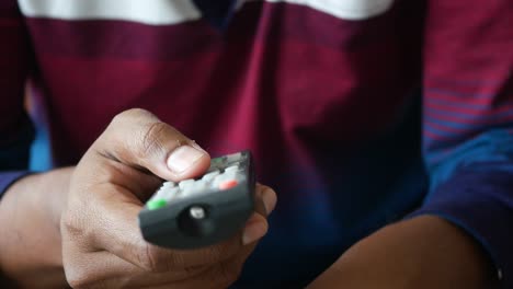 person holding a tv remote