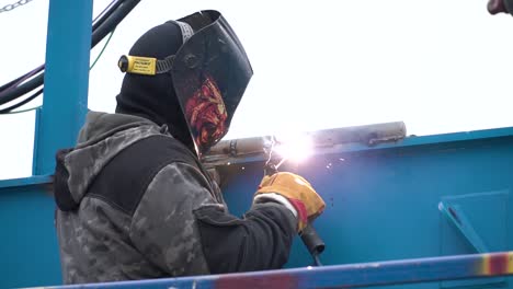 welder working on metal structure