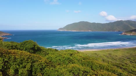 Aerial-view-Tayrona-tropical-lush-hillside-foliage-overlooking-scenic-turquoise-seascape-of-Norther-Colombia