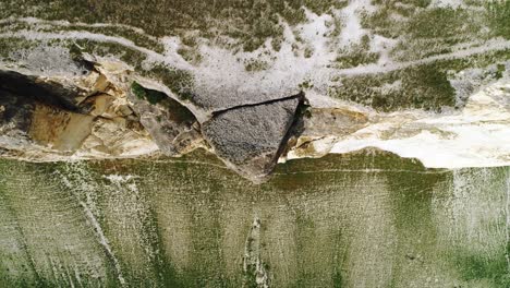 aerial view of rocky cliff and grassy terrain