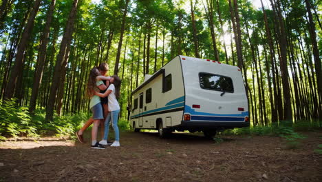 children playing happily near an rv in a sunlit forest