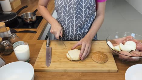 woman preparing a chicken burger