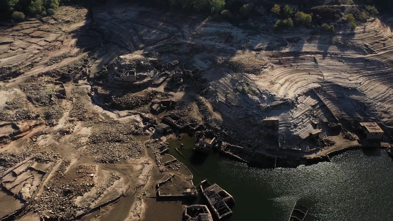 Drone Footage Of Ancient Village Ruins In A Reservoir Sunny And Clear Day