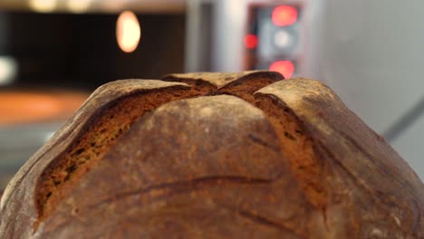 a freshly baked loaf of bread is removed from the oven in a cozy bakery setting