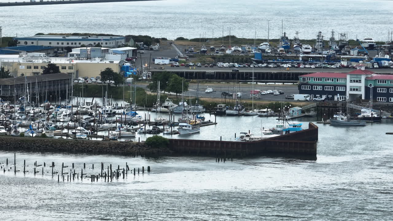 Telephoto drone shot of boats at the Newport marina, cloudy day in Oregon, USA