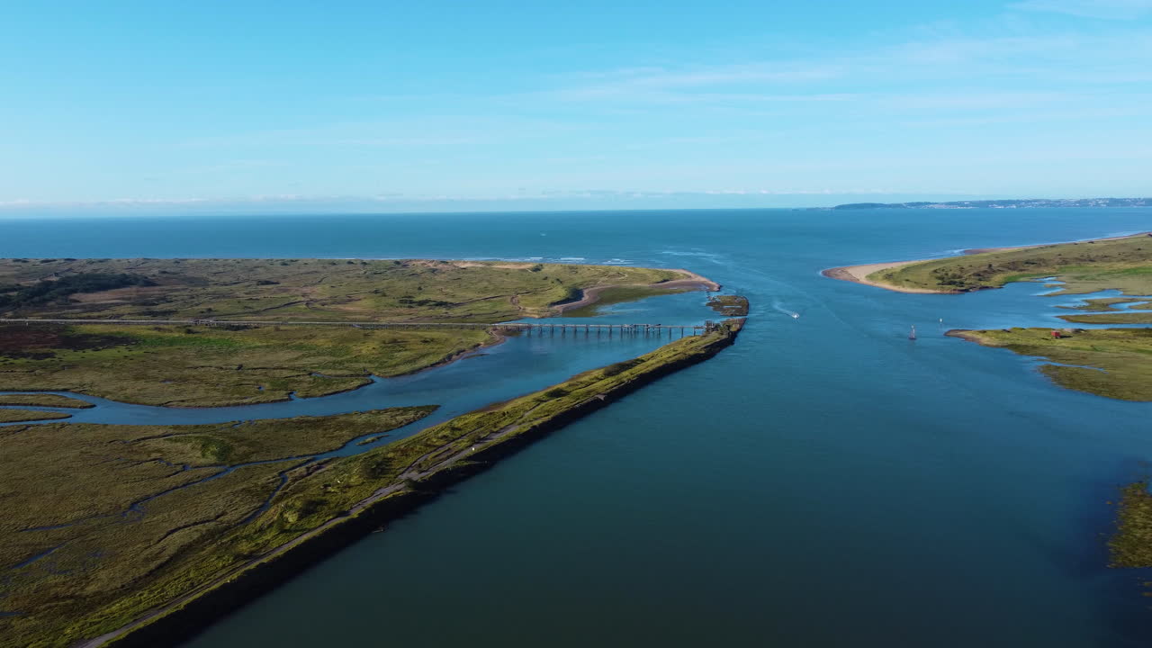 Aerial of Estuary Leading Out to Sea at High Tide with Calm Picturesque Blue Water in Port Talbot Facing Atlantic Ocean with Devon Hills in Distance