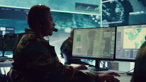 female army operator registers important information from surveillance system