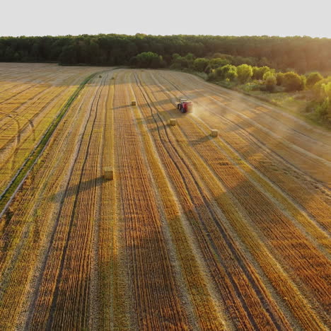aerial view of a tractor harvesting hay in a field.