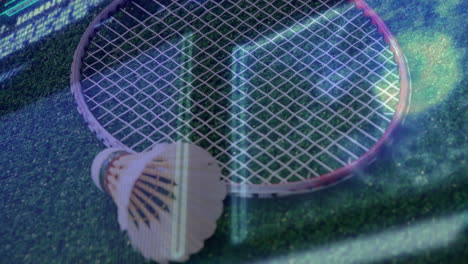 badminton racket lying flat beside shuttlecock on green court featuring neon graph lines shifting