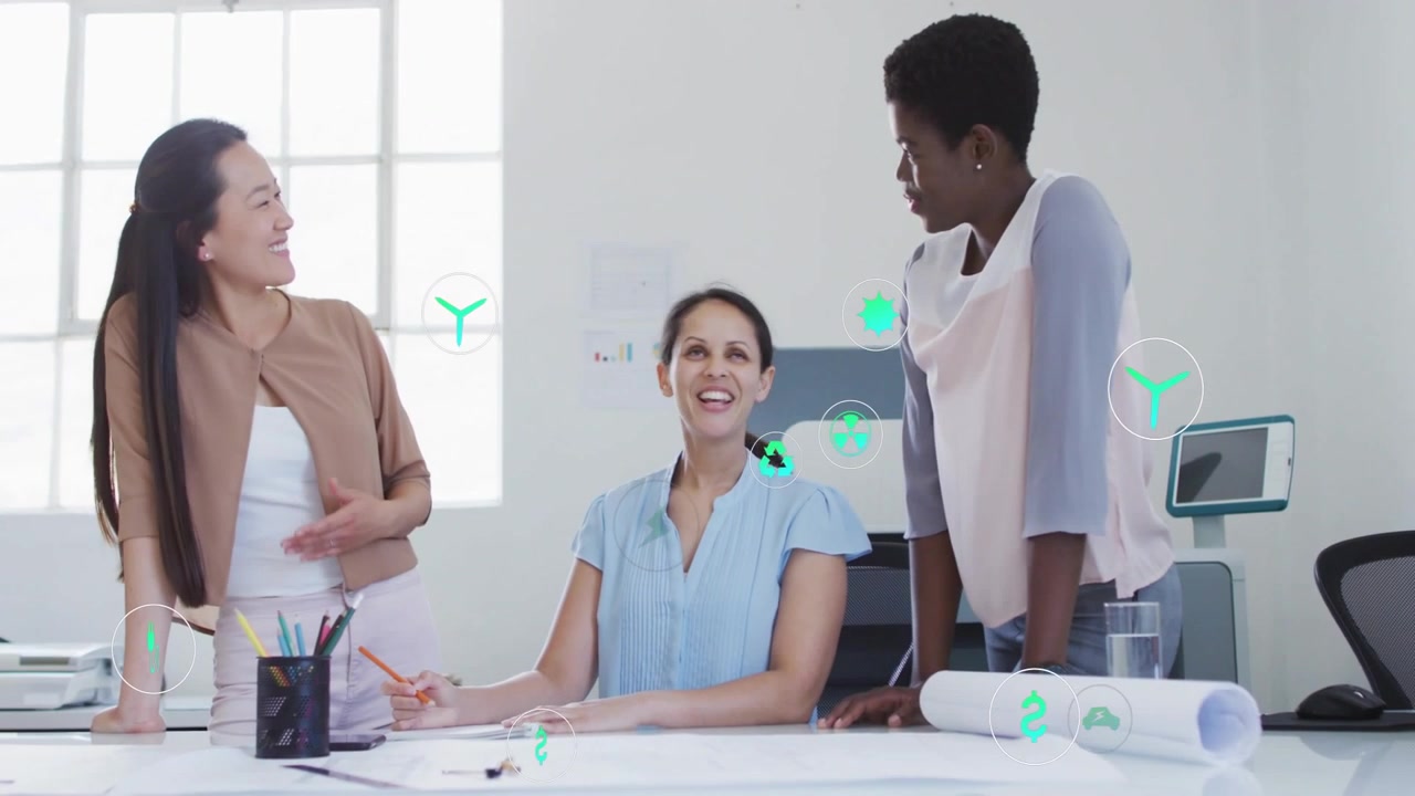 Three women reviewing plans, right-hand pointing, sparking teal icons mapping design progress