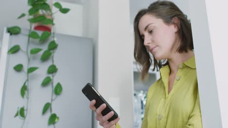 Caucasian-woman-wearing-yellow-shirt-and-using-smartphone