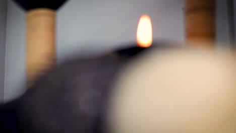 candlelight surrounded by decorative items in a wellness spa becoming gradually in focus