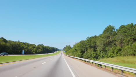 Driving-on-the-open-road,-under-a-bridge