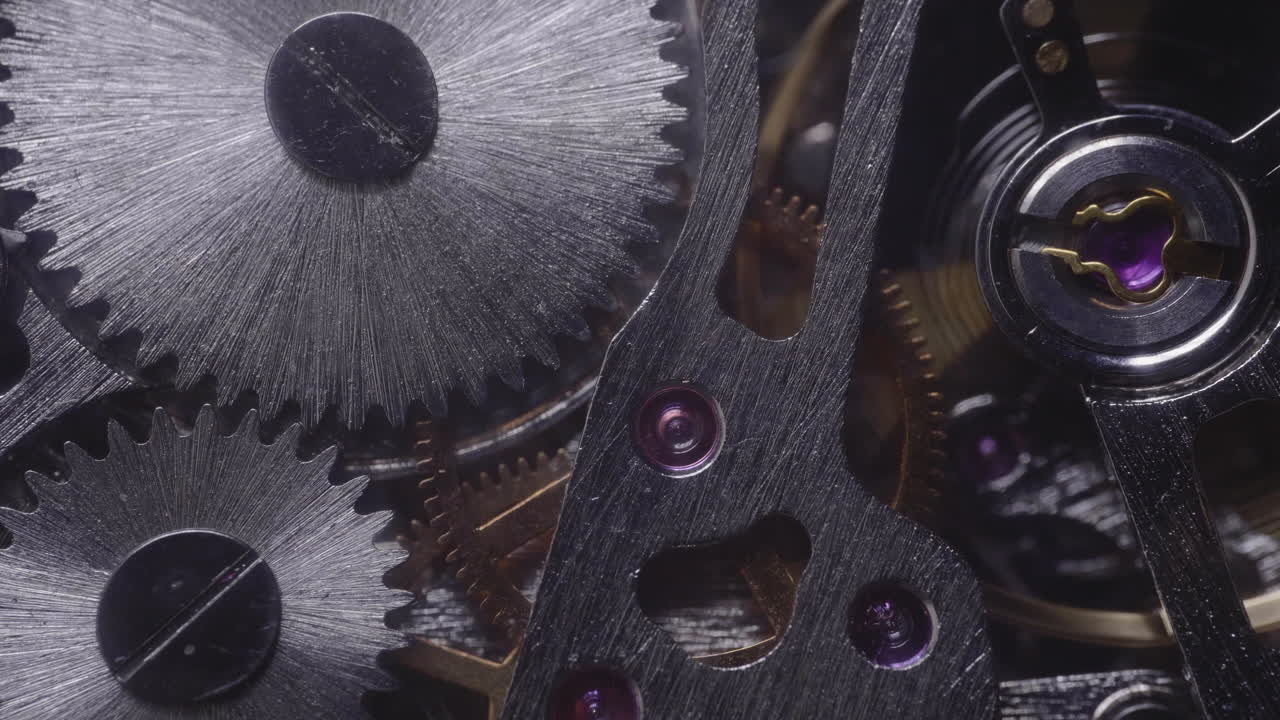 Light moving over shiny watch gears - Macro shot