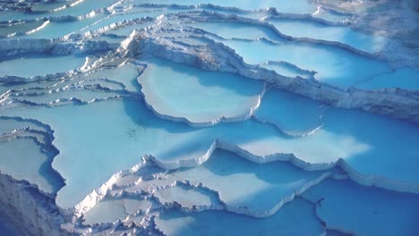 Steamy-blue-hot-springs,-mineral-waters,-forming-travertine-limestone-mineral-deposit-formations