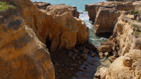 Vista-Of-Low-Rock-Ochre-Cliffs-At-Praia-do-Evaristo-In-Algarve,-Portugal