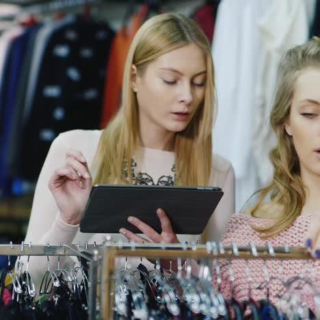 two friends choose warm winter clothes in the store 6