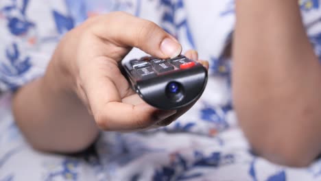 hand holding a tv remote control