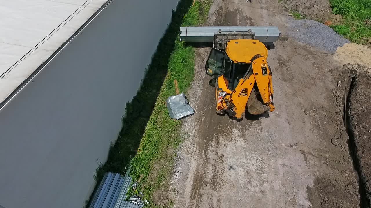 Construction machinery at work. Aerial view of tractor during work at construction site