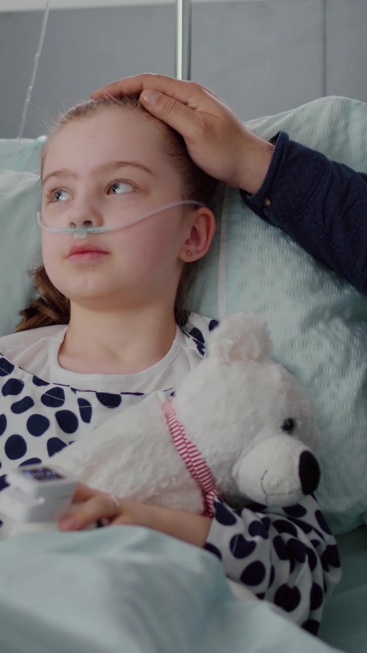 Young Girl Receiving Medical Care in Hospital Bed