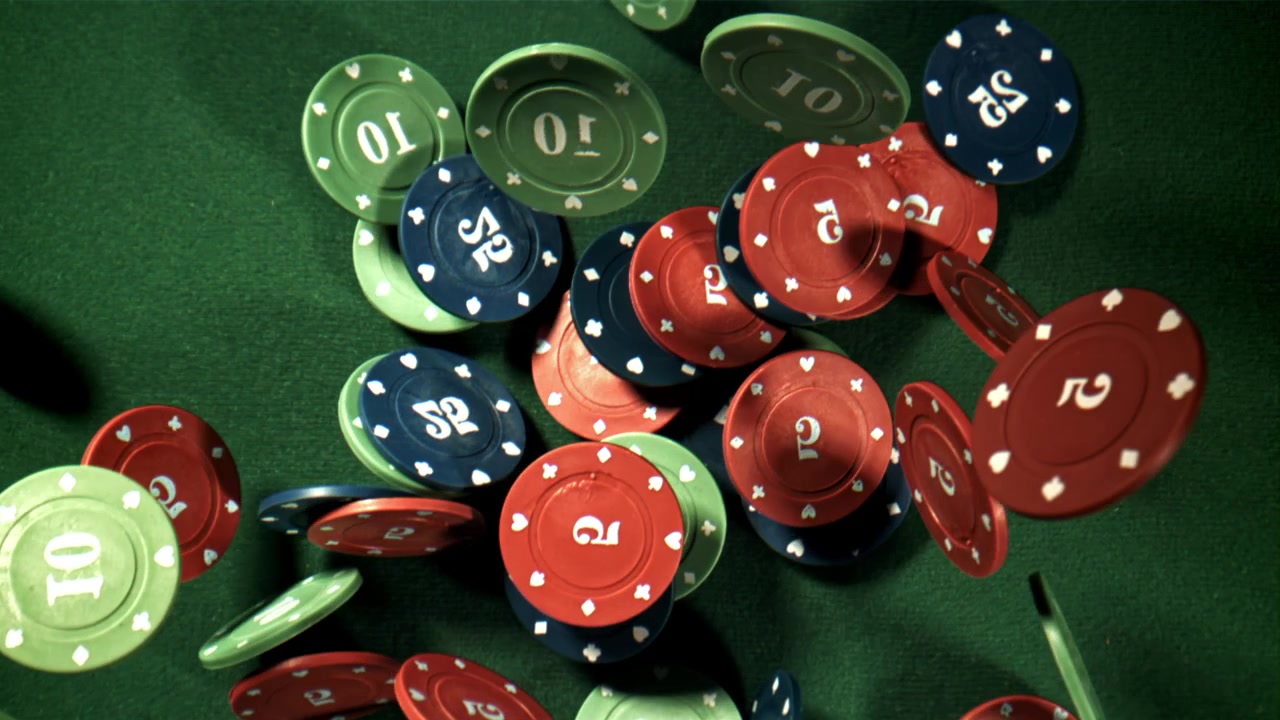 Slow Motion Poker Chips Falling onto a Green Felt Table